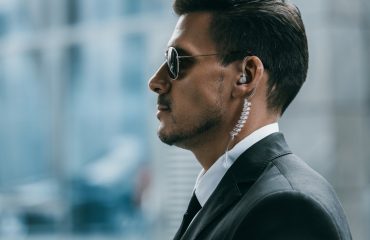 profile of handsome security guard with sunglasses and security earpiece